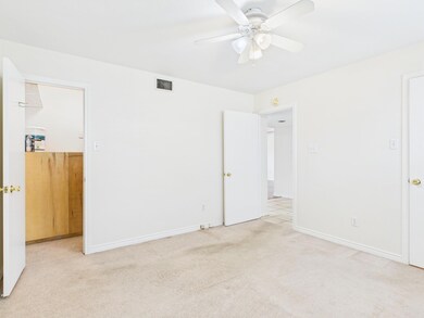 Unfurnished bedroom featuring visible vents, carpe