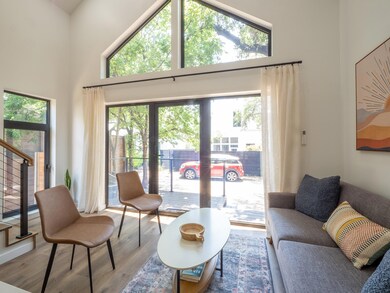 Living area with stairway, a high ceiling, wood f