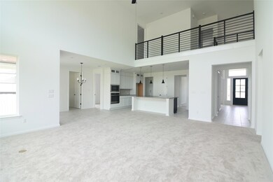 Unfurnished living room with a towering ceiling, 