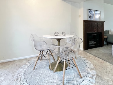 Dining space featuring tile patterned flooring and a fireplace