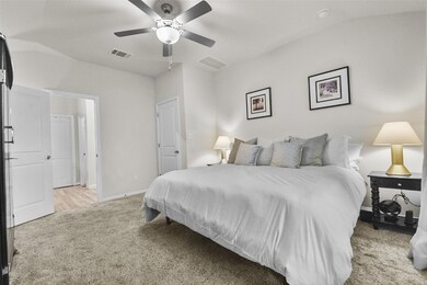Bedroom featuring light colored carpet, baseboard