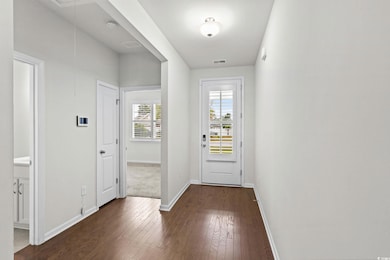 Entryway with baseboards and hardwood / wood-style floors