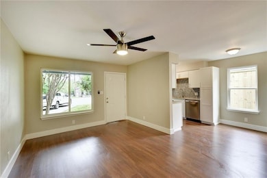 Unfurnished living room featuring ceiling fan, da