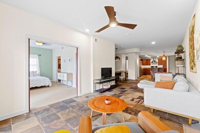 Living room with recessed lighting, stone tile fl