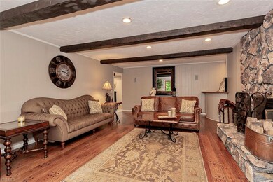 The rustic beams and stone fireplace offer a great