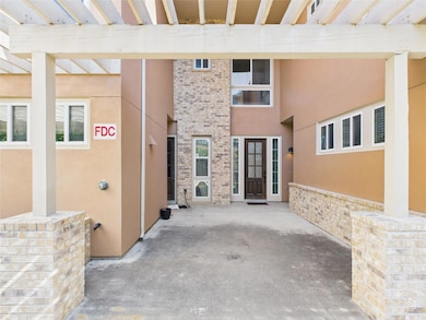 Entrance to property featuring brick siding and s