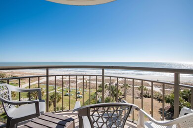 Balcony with view of water and beach