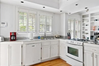 Kitchen featuring light wood-type flooring, stone 