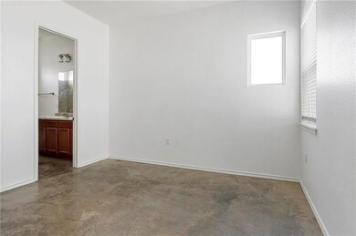 Empty room featuring baseboards, a sink, and fini