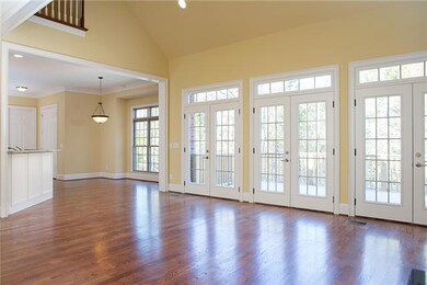 ANOTHER VIEW OF THE GREAT ROOM FLOWING INTO THE BREAKFAST ROOM AND KITCHEN.