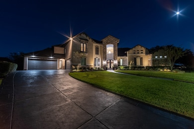 At night the front yard glows with soft lighting that elevates the entire property’s presence in the neighborhood.
