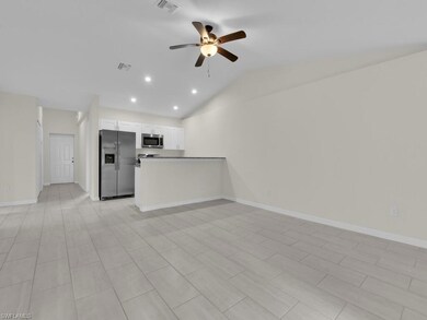 Unfurnished living room with ceiling fan, lofted ceiling, recessed lighting, and baseboards