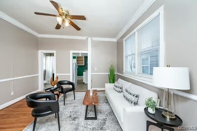 Living room with baseboards, wood finished floors,