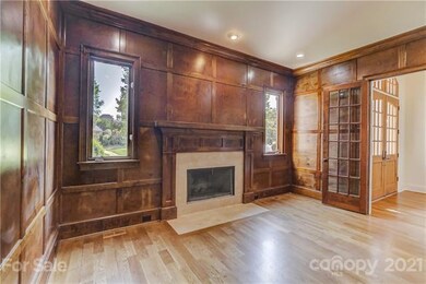 Wood paneled office w/gas fireplae