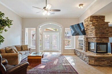 Large family room with stone gas log fireplace that opens to family room and dinette area.
