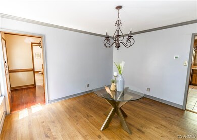 Wood floored empty room featuring a notable chande