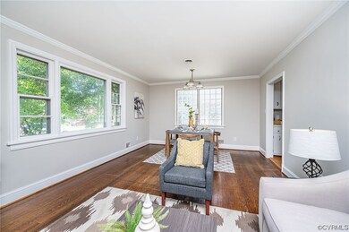 Living room has large picture window and a dining
