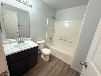 Bathroom featuring wood finished floors, a texture