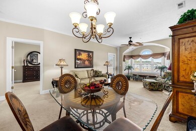Carpeted dining space featuring ornamental molding