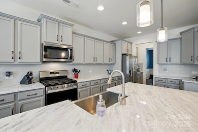 Stunning kitchen with a massive island is open to great room.