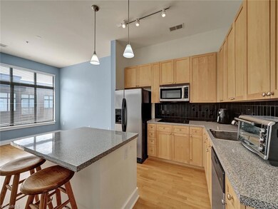 The kitchen has an island and stainless appliances