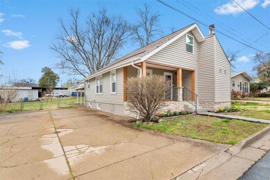 Over sized driveway leads to fenced backyard.