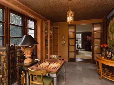Sun room looking into the living room through custom French doors
