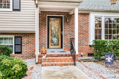 Welcoming Entryway with Covered Stoop, Storm Door and Custom Wood & Decorative Glass Door