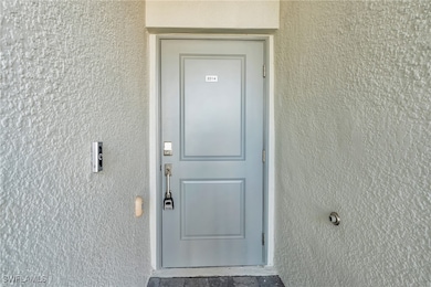 Entrance to property with stucco siding