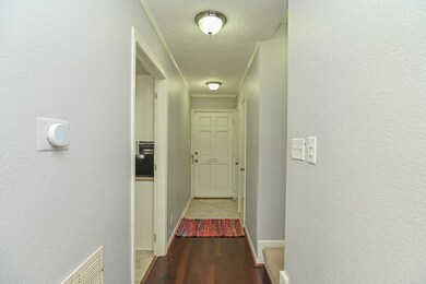 Front entry with laminate floor and neutral tile.