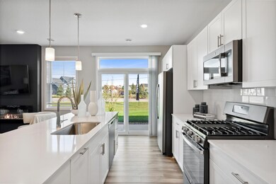 A Spacious kitchen and dinette with convenient sliding glass door. *Photos of model home; colors and finishes will vary.