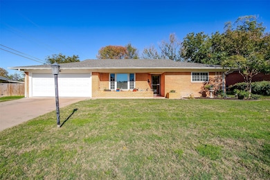 Ranch-style house with concrete driveway, an attached garage, brick siding, and a shingled roof