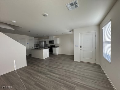 Unfurnished living room featuring dark wood finish