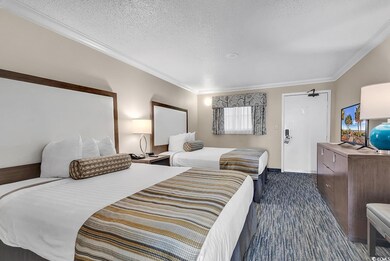 Bedroom with dark carpet, a textured ceiling, and 