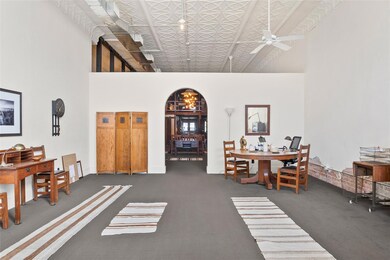 Dining space with arched walkways, ceiling fan, ca
