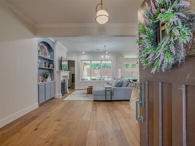 Spacious Foyer to great guest giving you a beautiful craftsman front door, designer lighting, modern baseboards and wood flooring.