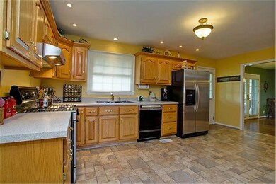Another view of the kitchen with like new flooring-Abundance of oak cabinets and lots of counter space