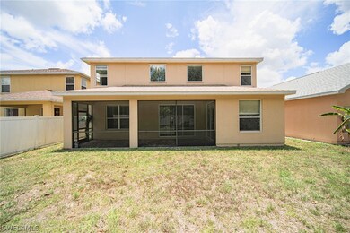 Back of house featuring a sunroom and a lawn