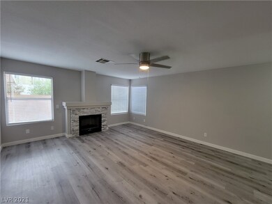 Living room with stone façade and ceiling fan