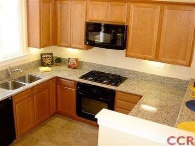 Granite countertops, drop-in sink, tile flooring