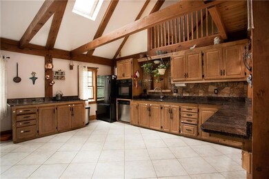 The roomy kitchen has a cathedral...