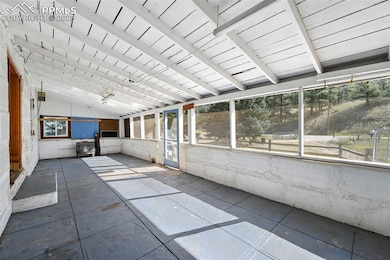Unfurnished sunroom with beamed ceiling, a healthy