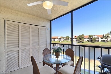Sunroom with ceiling fan, a balcony, outdoor dining space, and a water view