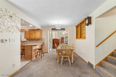 Dining area featuring light colored carpet and stairway