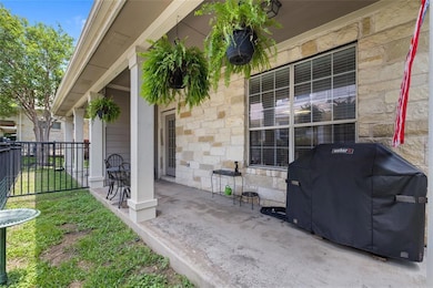 View of patio featuring a grill and fence