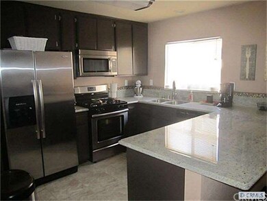 ANOTHER VIEW OF THE KITCHEN FEATURING CERAMIC TILE