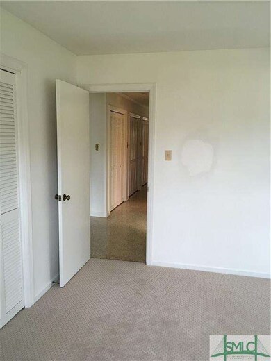 one of two bedrooms with new carpet, which share a