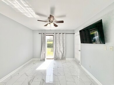 Empty room featuring marble finish floor, baseboar