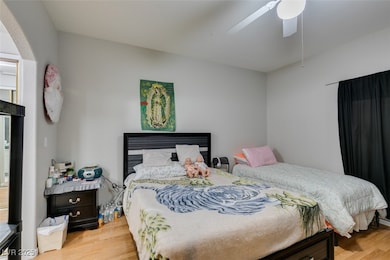 Bedroom with wood finished floors and a ceiling fa