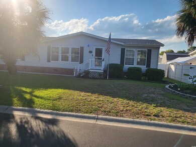 View of front of house with crawl space, fence, an